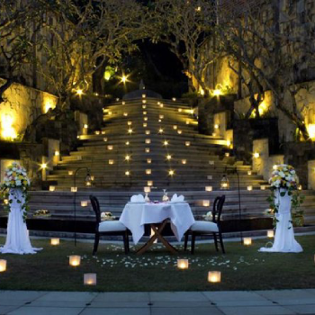 table and chairs surrounded by candles