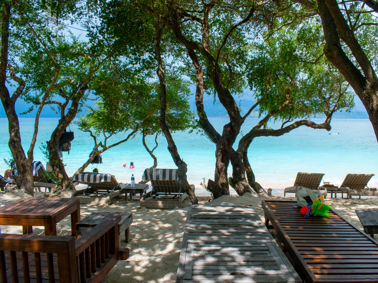 cozy underneath trees seating area on the south beach 1 gili trawangan